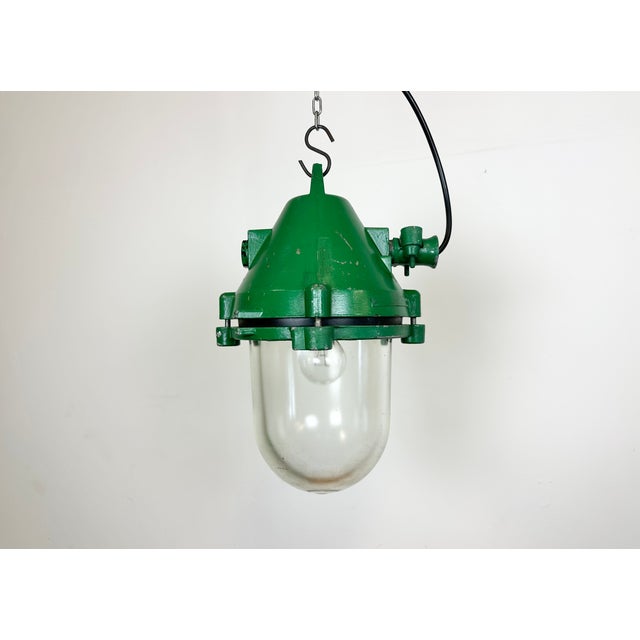 Green industrial explosion proof light with massive protective glass bulb. Made in former Czechoslovakia by Elektrosvit...