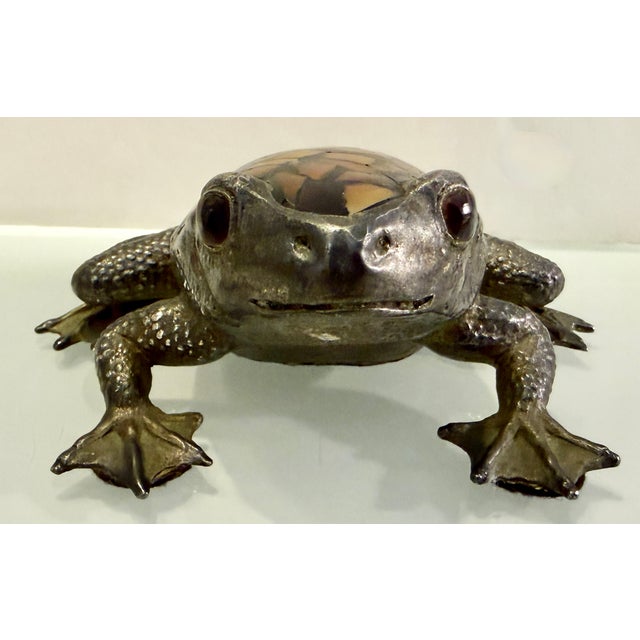 This vintage silver-plated frog paperweight is a charming and whimsical decorative piece by Maitland Smith. The frog...