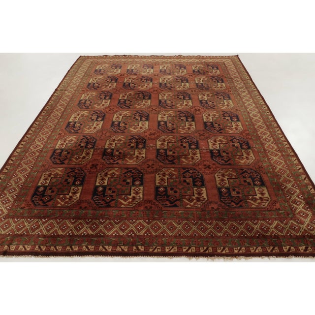 This 8x11 antique Tetex rug, hand-hooked in wool circa 1920–1929, features an allover field of geometric gul motifs framed...