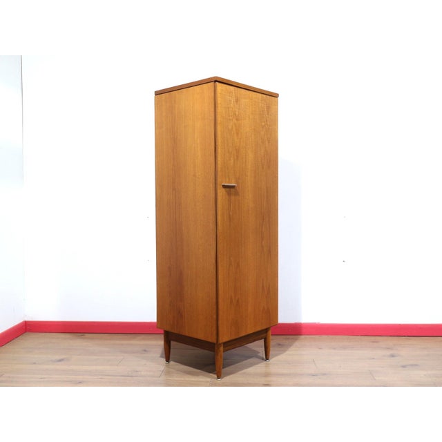 This Mid Century Modern Vintage Teak Single Armoire Wardrobe by White and Newton is a rare piece of furniture designed...