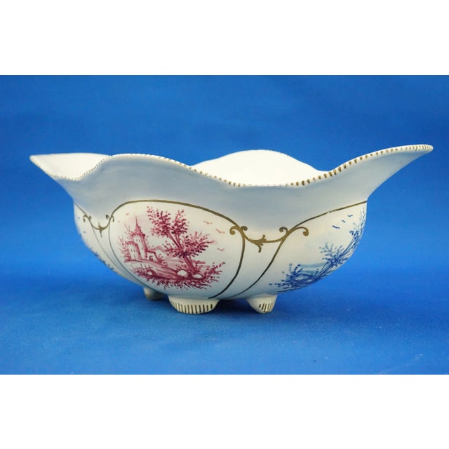 A stunning small glazed ceramic centerpiece, entirely hand-decorated with monochrome landscapes in shades of blue and...