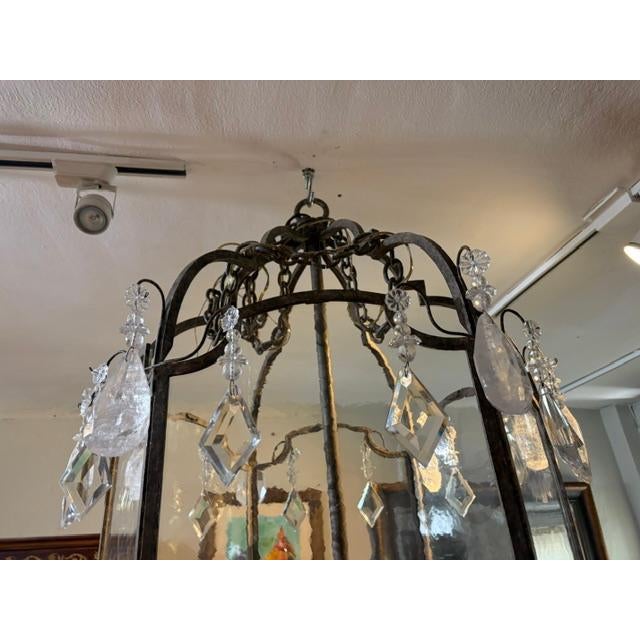 This product is a large French-style metal lantern with frosted glass panels, designed in an antique reproduction style....