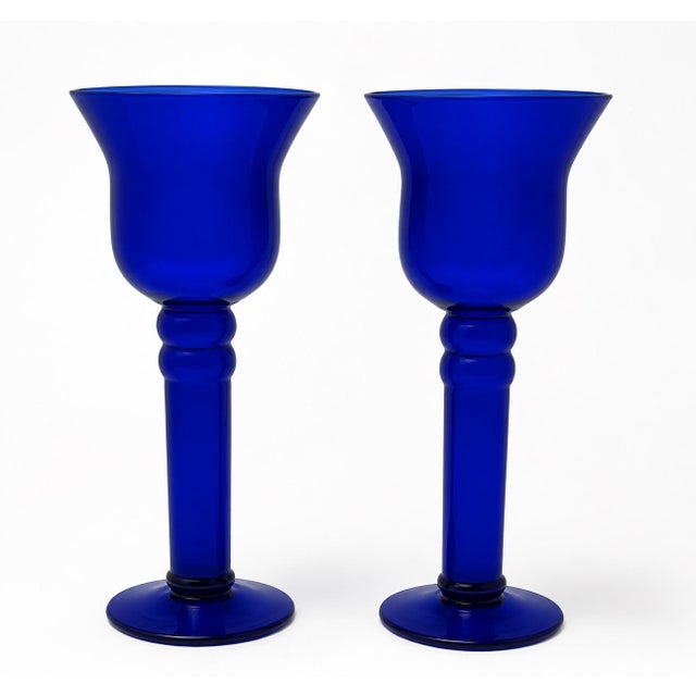 Beautiful pair of cobalt blue hand-blown glass candlesticks with a graceful, sculptural silhouette and rich saturated...