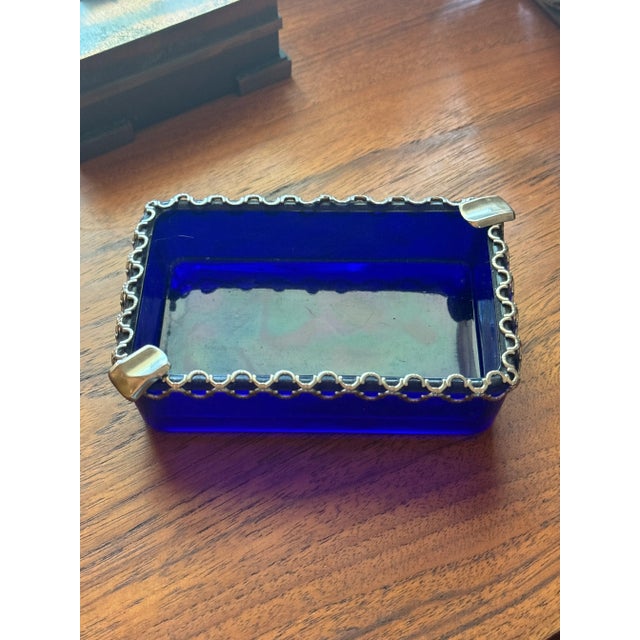 Vintage art deco cobalt blue ash tray with metal detail, circa 1930s. 1.5” H x 5” W x 3” D