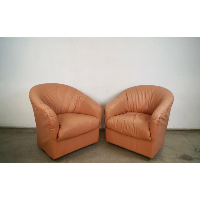 Pair of 1980's Post Modern Art Deco swivel lounge chairs for sale. These are in pink leather, and are in great condition....