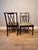 This elegant pair of Regency-style mahogany side chairs has been professionally restored and newly upholstered in high-end...