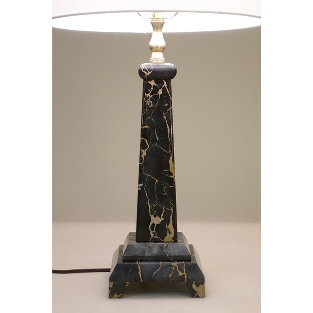 A sophisticated and elegant Black & Gold "Portoro" Marble & Brass Art Deco revival Obelisk Column table lamp designed and...