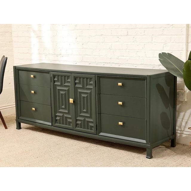 A striking vintage credenza refinished in a deep, moody green with crisp brass-tone hardware for just the right hit of...