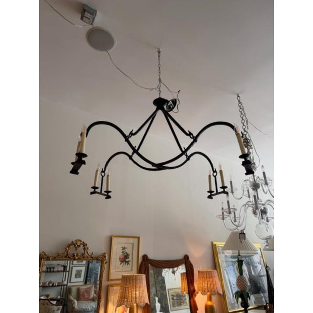 This is a Dennis and Leen Gothic iron chandelier. This is beautifully made with a distressed iron and 8 bulbs with was...