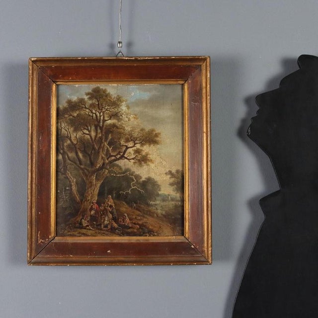 Oil on panel. Flemish School, 18th century. In a country landscape with a path winding through twisted trees, a group of...
