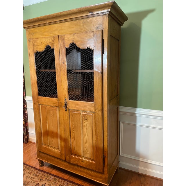 A striking example of 19th-century French provincial craftsmanship, this authentic Cheese Armoire dates to circa 1860 and...