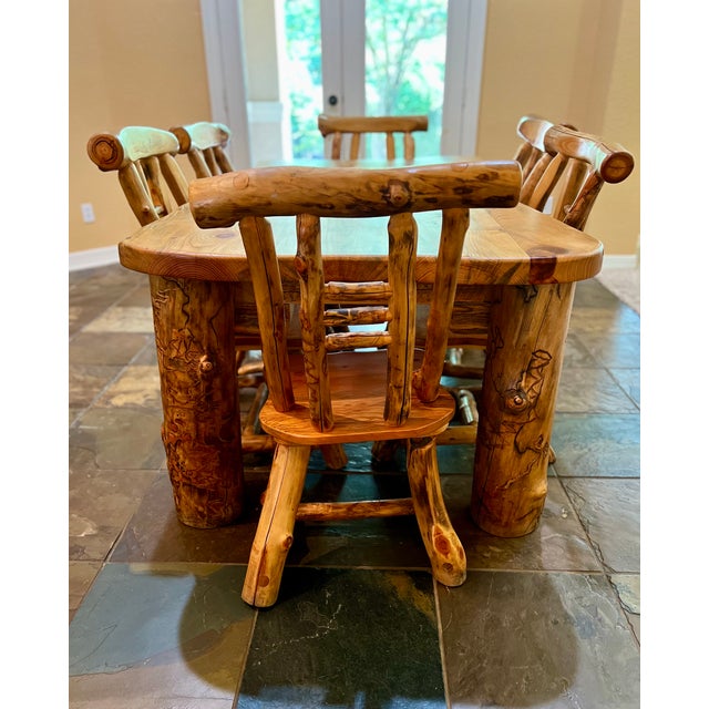 Extraordinary CUSTOM MADE Aspen log Dining room table and matching six chairs, complete with gnarly log finish....