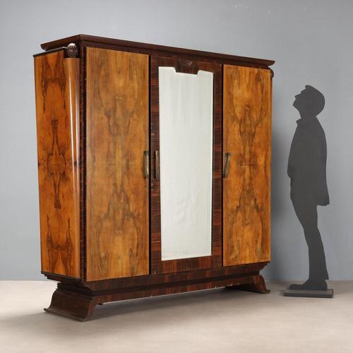 Art Deco wardrobe in walnut and rosewood veneer. Three-door front, the central one with beveled mirrors and a pair of...