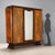 Art Deco wardrobe in walnut and rosewood veneer. Three-door front, the central one with beveled mirrors and a pair of...