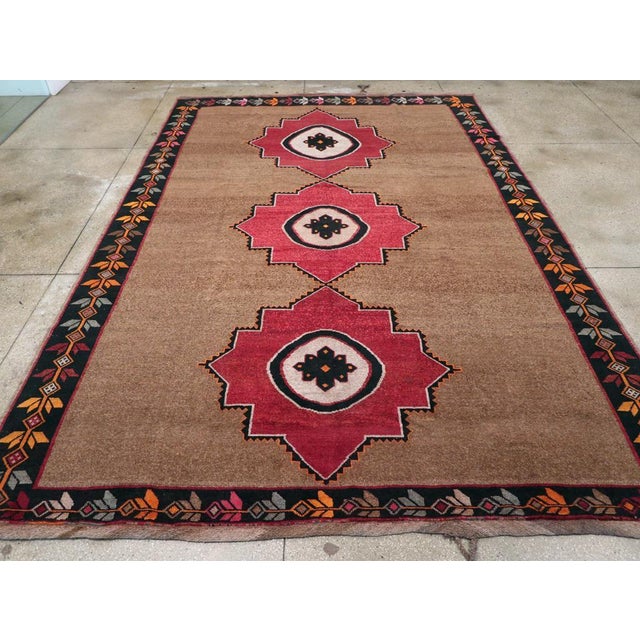 A vintage Turkish Anatolian tribal room size carpet handmade during the mid-20th century. Measures: 10' 0" x 14' 11"