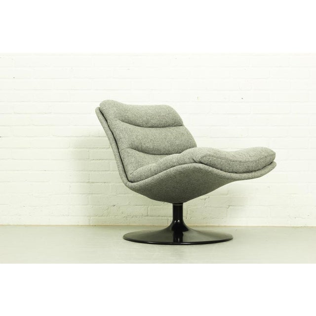 A mid-size armchair designed by Geoffrey Harcourt for Artifor with smooth curves and a swivel function that offers...