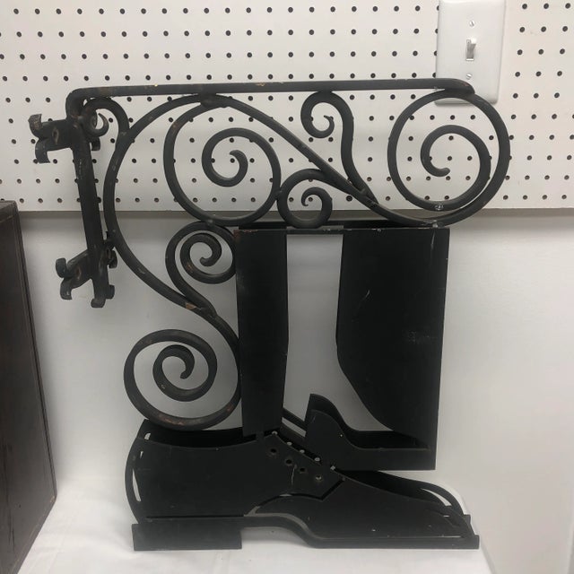 Hanging English circa 1940 iron shoe & bookmakers trade sign. Very unusual to find one sign depicting both items.