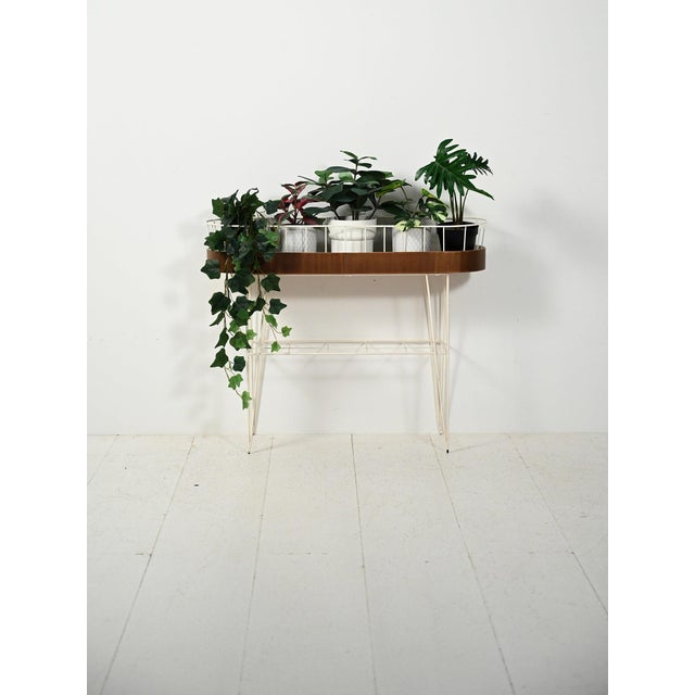Scandinavian flower stand from the 1960s in white lacquered metal with teak inserts, featuring a light and functional...