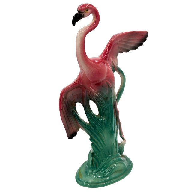 Set of two Mid-century pink and green ceramic open-wing flamingo tabletop pottery statues. Each statue features a...