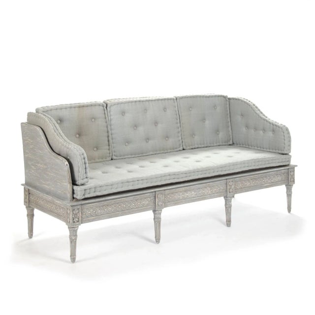 Bench with intricate details in distressed dove grey finish with tufted cushions upholstered in grey blue raw silk.