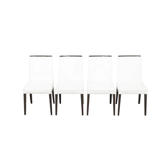 A refined set of four Cantoni One and Only dining chairs, these pieces combine crisp white leather, dark espresso-finished...