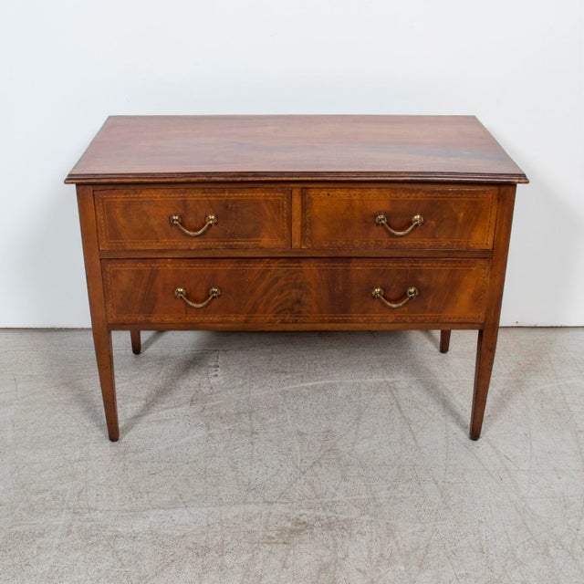 An exceptional 19th century French Louis XVI style commode sauteuse handcrafted of walnut by skilled artisans near...