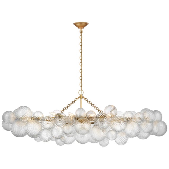 Talia Large Linear Chandelier in Gild with Clear Swirled Glass Designer: Julie Neill Canopy: 6" Round Mounting: Chain...