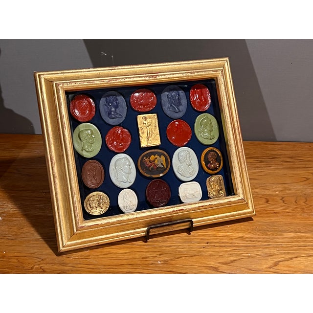 Italian gilt wood shadow box frame with glass cover and twenty fit placed multicolor painted, hand painted and gilded...
