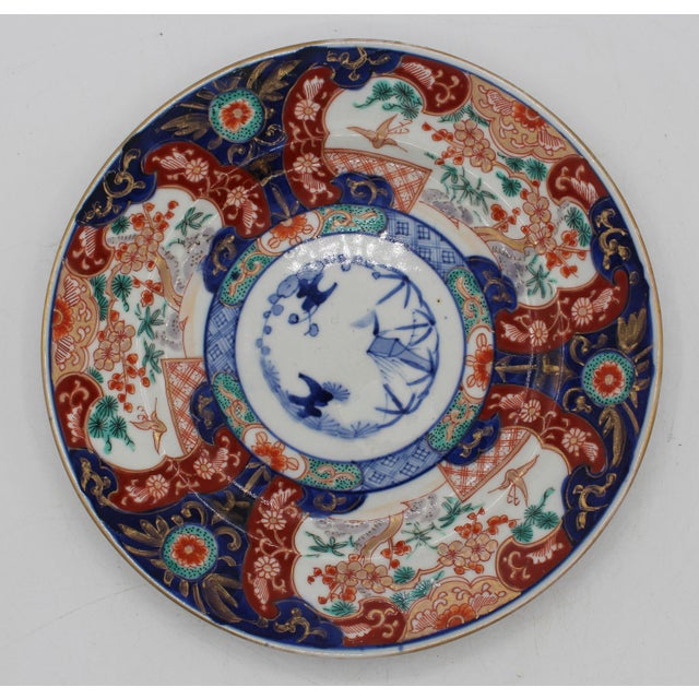 Circa 1860 Imari plate, Japanese. Large border reserves & fine geometric inner border. Pine trees, prunus, bamboo & cranes...