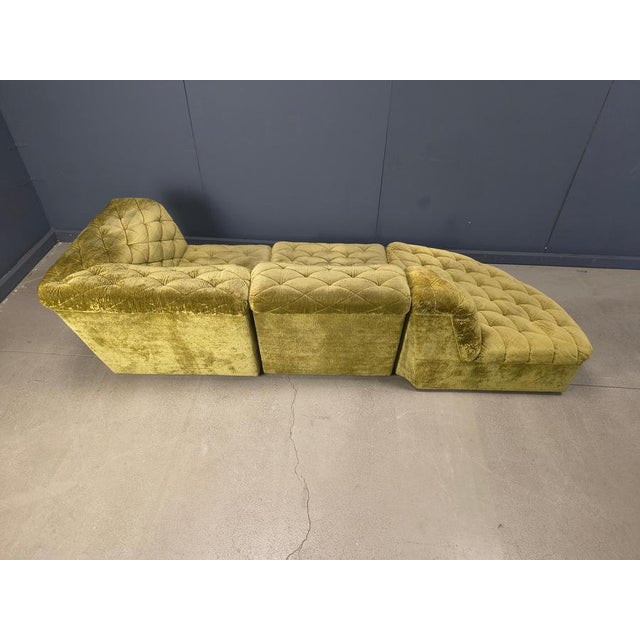 Seventies olive green velvet fabric sofa with 3 seating elements. Cool shape for smaller living rooms or a waiting room,...