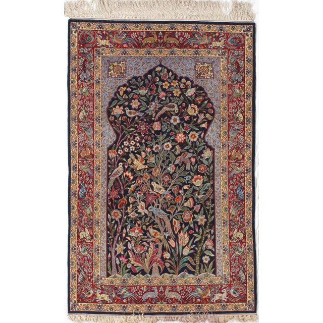 Vintage hand-knotted Persian Isfahan wool rug on a silk foundation, featuring a pictorial garden scene with birds,...