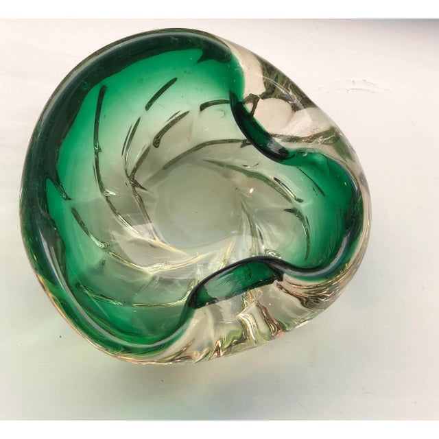 This gorgeous green gem catches and disperses light beautifully. The submerged green is surrounded by a translucent swirl...