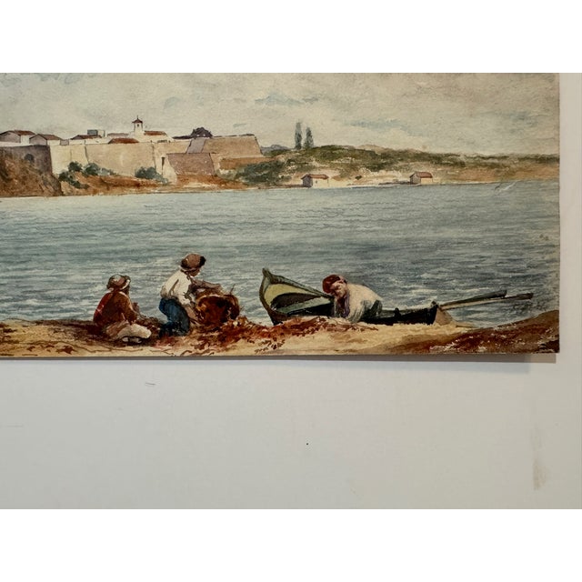 Original watercolor on paper, signed Frank Henry Mason, depicting a coastal fortress overlooking calm blue-gray water...