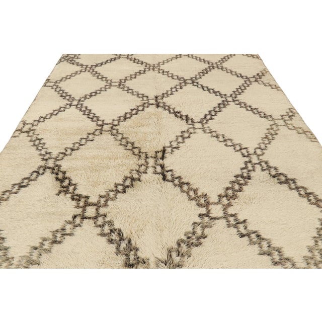 Hand-knotted in wool and originating from Morocco circa 1950-1960, this 7x14 vintage Moroccan rug is an extremely rare...