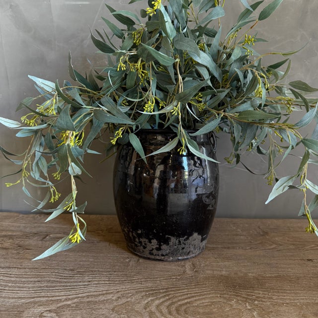 Medium black glazed pottery, wabi sabi style with perfect imperfections. Size: 8.5"D x 10"H Opening: 6"