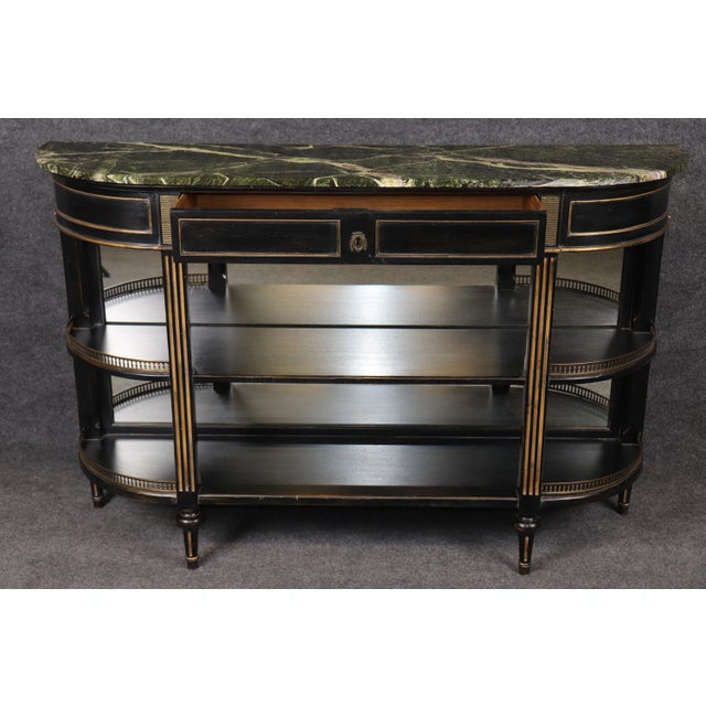 Elevate your interior with this exceptional French Louis XVI style marble top sideboard, dating to the early 1900s and...
