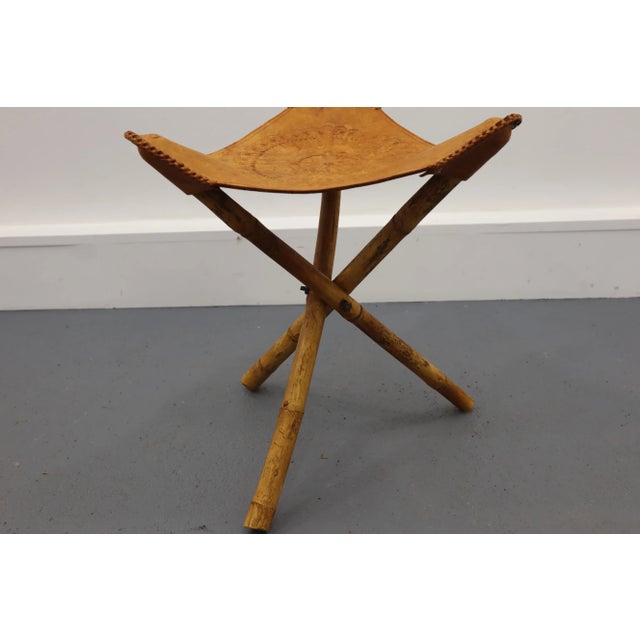 A pair of safari stools made in the 1970s, made of natural leather and rattan. Foldable.