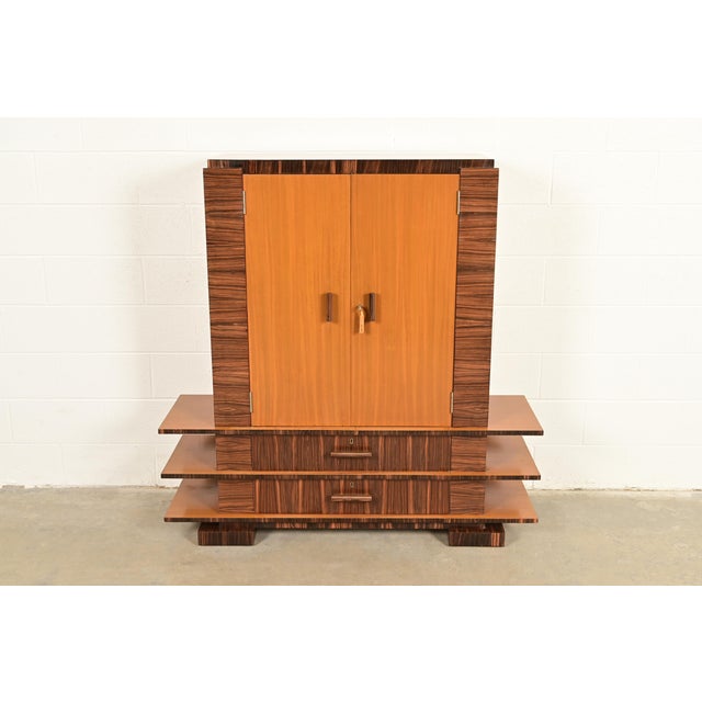 A beautiful Art Deco period Macassar ebony and mahogany armoire dresser, gentleman's chest, or linen press In the manner...