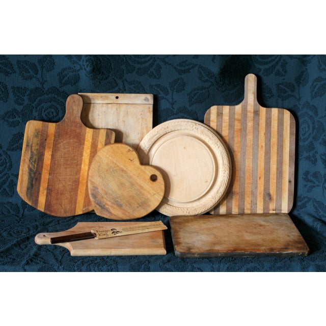 A very unique wood cutting board or cheese plate shaped like a heart with a hole for hanging. Unsure of origin. Great but...