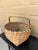 A beautifully woven early 20th century American splint oak basket with warm honeyed tones and a tightly constructed...