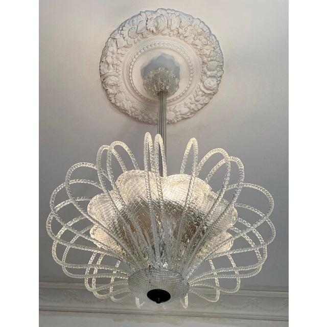 An extremely delicate and elegant chandelier by the famous Murano factory Barovier & Toso. Nearly two dozen glass spouts...