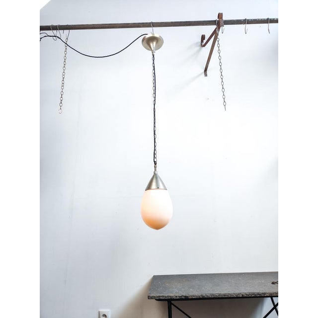 Beautiful 1920’s German Bauhaus pendant light, opaline glass suspended by a nickel plated brass gallery. The pendant is...