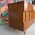 This American of Martinsville mid-century modern credenza listing features a walnut wood frame, nine drawers with sculpted...