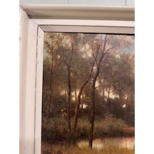 This is an 20th Century atmospheric landscape oil on canvas, circa 1920s, featuring a tranquil river scene in a...