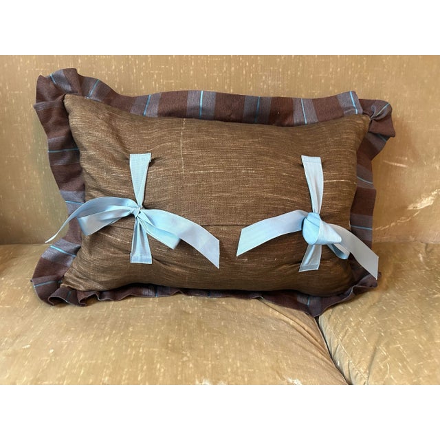 A pillow hand made from a circa 1920s English floral printed linen, edged and backed with coordinating fabrics, a down...