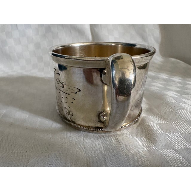 A beautiful silver-plate mug engraved with a ship in full sail on one side and the words "Grandma 1824-1907" and "From...