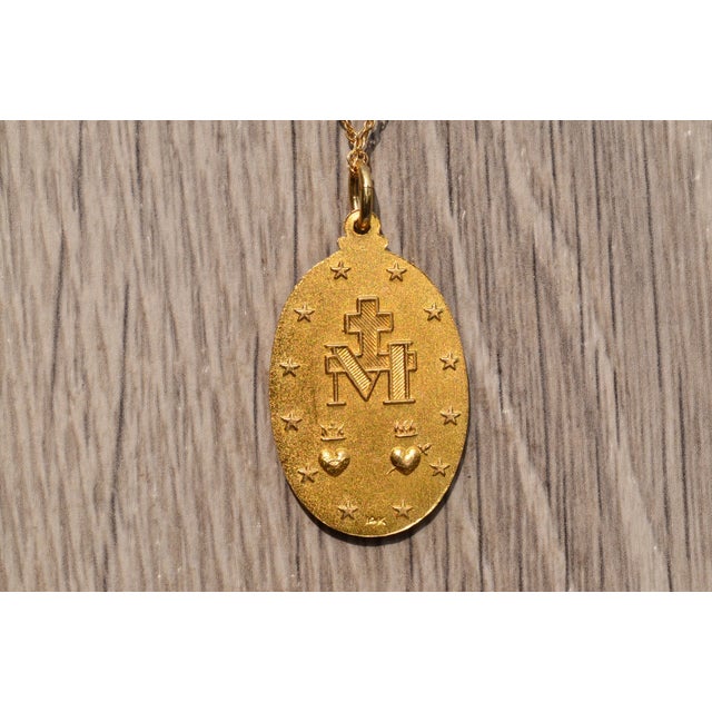 The Altura Place 14 Karat Yellow Gold Virgin Mary Medal. On a 16 inch rope style chain hangs a 1.25 inch length medal...