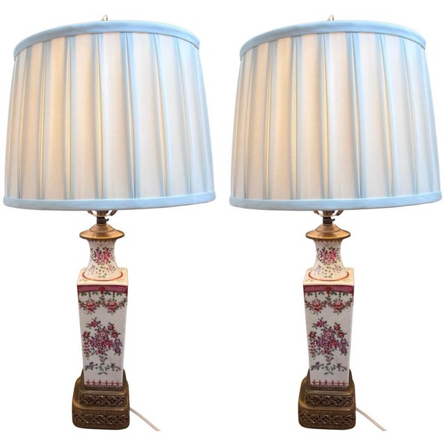A stunning pair of antique Chinese vase lamps made of porcelain in the Famille Rose design, originating from Canton during...