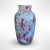 A striking studio art pottery vase featuring a rich, flowing drip glaze in vivid tones of blue, red, green, and hints of...