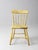 An antique primitive plank seat chair dating to the early 20th century, featuring a shaped wooden seat, tapered legs, and...